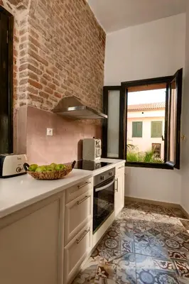 a kitchen with a sink and a counter top at Monastery apartment, a unique house in Chania Town