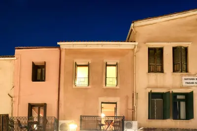 a building with lights in the windows at night at Monastery apartment, a unique house in Chania Town