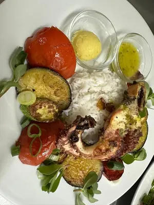 a white plate of food with rice and vegetables at Hotel Plakures in Falasarna