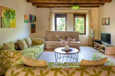 a living room with two couches and a table at Villa Erontas -Private heated jacuzzi and mini pool in Makhairoí