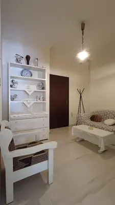 a living room with a white dresser and a couch at Dominic Chania Center Apartment in Chania Town
