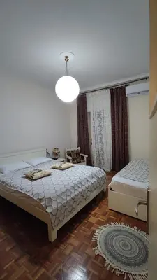 a bedroom with two beds and a lamp at Dominic Chania Center Apartment in Chania Town