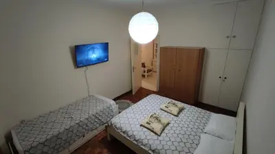 a small room with two beds and a tv at Dominic Chania Center Apartment in Chania Town