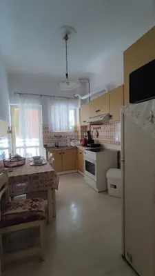 a large kitchen with a table and a kitchen with a tableablish at Dominic Chania Center Apartment in Chania Town