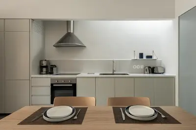 a kitchen with a wooden table with two plates on it at Lofos Casteli Sunlight in Chania Town