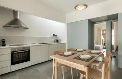 a kitchen with a wooden table and chairs in it at Lofos Casteli Sunlight in Chania Town