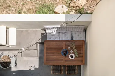 an overhead view of a balcony with a clock at Lofos Casteli Sunlight in Chania Town