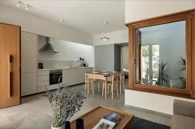 a kitchen and living room with a table and chairs at Lofos Casteli Sunlight in Chania Town