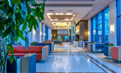 a lobby of a building with blue and red furniture at Porto Platanias - Casa Di Porto in Plataniás
