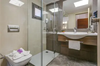 a bathroom with a toilet and a sink and a shower at Porto Platanias - Casa Di Porto in Plataniás