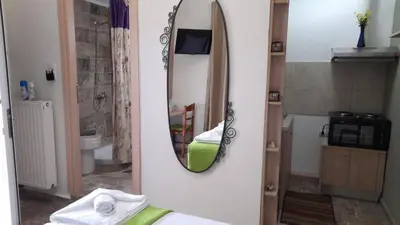 a bathroom with a mirror on a wall at Kissamos Nice Apartment1 in Kissamos