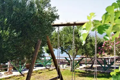 a group of wooden swings in a park at Villa Akrolithos with Private Pool in Chania Town