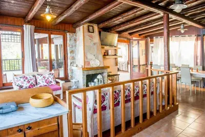a living room with a fireplace in a house at Villa Akrolithos with Private Pool in Chania Town