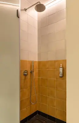 a bathroom with a shower with a glass door at Flâneur in Chania Town