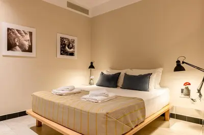 a bedroom with a bed with two towels on it at Flâneur in Chania Town