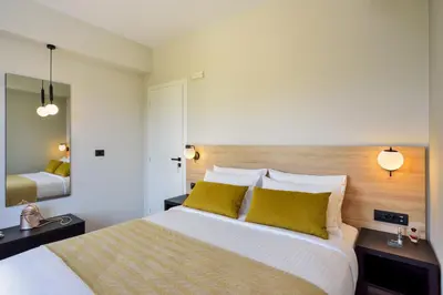a bedroom with a large bed with yellow pillows at Dandelion apartments in Chania Town