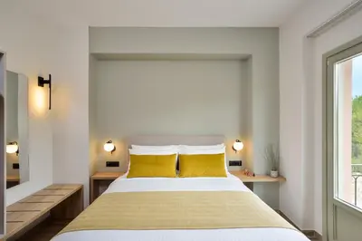 a bedroom with a large bed with yellow pillows at Dandelion apartments in Chania Town