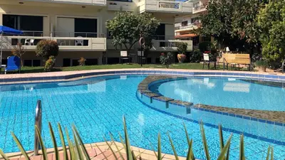a large swimming pool in front of a building at Lefka Apartments in Parigoría