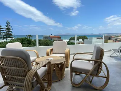 a group of chairs and a table on a balcony at Mira Sea View Residence in Chania Town