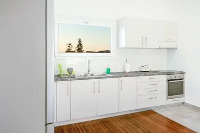 a white kitchen with a sink and a window at Mira Sea View Residence in Chania Town