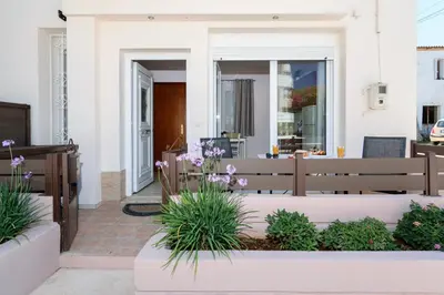 a house with a patio with purple flowers at Marianthi's Maisonette in Chania Town
