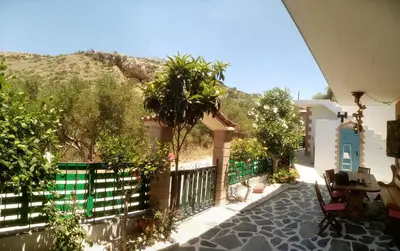 a view of a house with a fence and trees at Village Villa Mimis Drapanias in Drapaniás