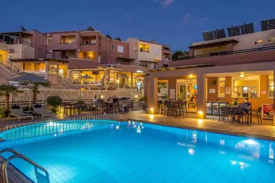 a large swimming pool in front of a building at Theos Holidays Apartments in Kato Daratso