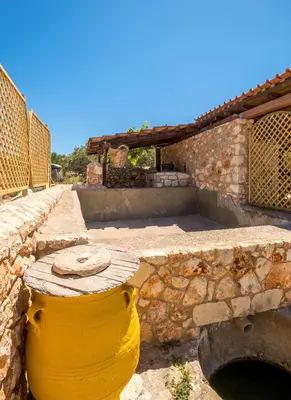 a yellow barrel sitting next to a building at Traditional Cretan Villa George - Private Pool in Kambánion