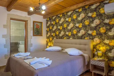a bedroom with a bed with towels on it at Traditional Cretan Villa George - Private Pool in Kambánion