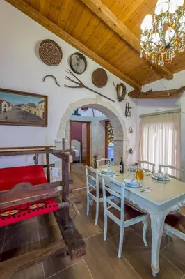 a kitchen and dining room with a table and chairs at Traditional Cretan Villa George - Private Pool in Kambánion