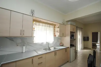 a kitchen with white cabinets and a sink and a window at Apartment close to Balos-Elafonisi and Falasarna! in Kámbos