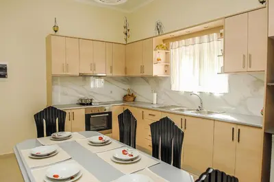 a kitchen with a table with chairs and a sink at Apartment close to Balos-Elafonisi and Falasarna! in Kámbos