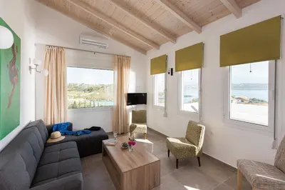 a living room with a couch and a table at Villa Kiara 2 in Tersanas