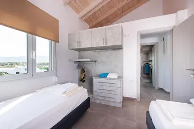 a bedroom with two beds and a window at Villa Kiara 2 in Tersanas