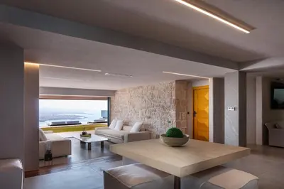 a living room with a table and a couch at Cavo Dago in Chania Town