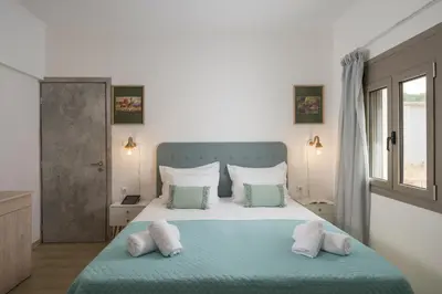 a bedroom with a blue and white bed with pillows at Villa Alitocatos in Drapaniás