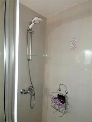 a shower with a shower head in a bathroom at Emerald Apartment 2 Halepa in Chania Town