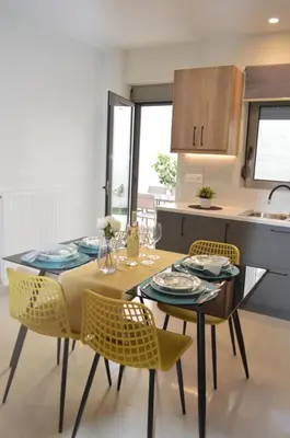 a kitchen with a dining table and chairs in a kitchen at Leonidas House in Chania Town