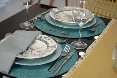 a table with blue and white plates and wine glasses at Leonidas House in Chania Town