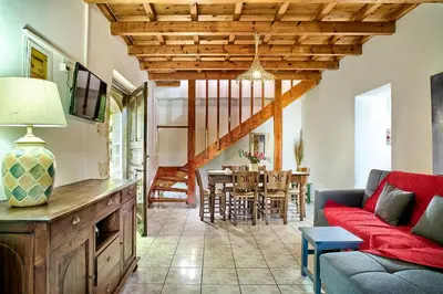 a living room with a couch and a table at Platanos Stone House I With Shared Pool in Kalyves
