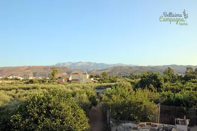 a view of a farm with mountains in the background at Bellisima Campagna Home pelekapina -chania crete in Chania Town