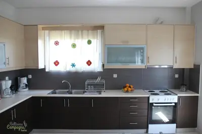 a kitchen with a sink and a stove top oven at Bellisima Campagna Home pelekapina -chania crete in Chania Town