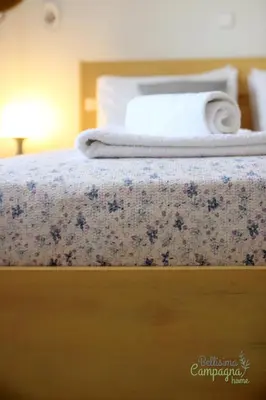 a bed with a white towel on top of it at Bellisima Campagna Home pelekapina -chania crete in Chania Town