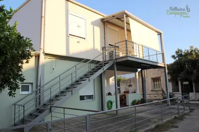 a building with stairs on the side of it at Bellisima Campagna Home pelekapina -chania crete in Chania Town
