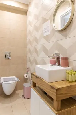 a bathroom with a white sink and a mirror at Mitos Cozy Rooms in Chania Town