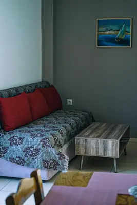 a living room with a bed and a coffee table at Tasos Seagull apartments in Chania Town