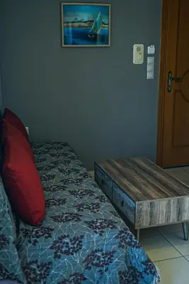 a bedroom with a bed with a bench on it at Tasos Seagull apartments in Chania Town