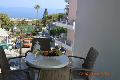 a table with a bowl of fruit on a balcony at Filia Luxury Apartment in Chania Town