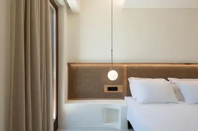 a bedroom with a bed and a pendant light at The Authentic Village Boutique Hotel in Khóra Sfakíon