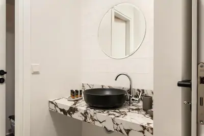 a bathroom with a sink and a mirror on a counter at Lux sea view villa by Chania LIving Stories in Chania Town